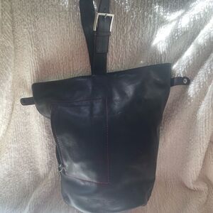 Acosta leather black bucket style shoulder bag with red stitching accents .